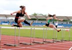 Micaela Brindle (Wigan Harriers) and far right Kelly Clark (City of Sheffield)  winner of the under-20 100 metres hurdle, Northern Championships, Sport City, Manchester